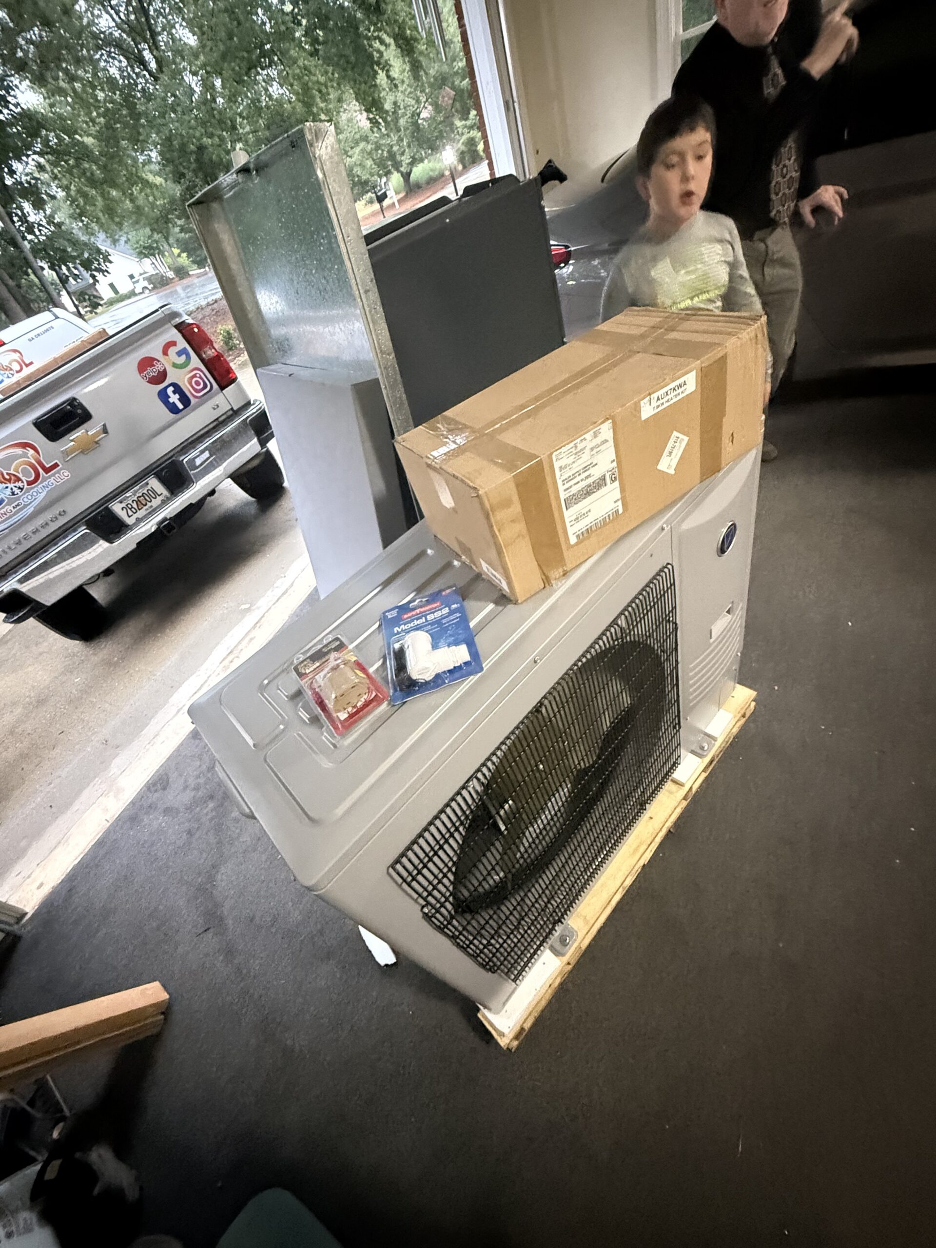 B-Cool technician diagnosing an AC system on an Alpharetta service call